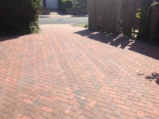 Red herringbone block paving driveway