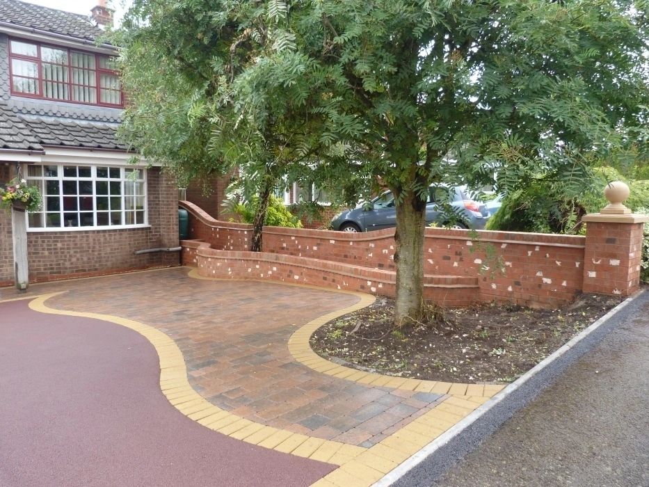 Red tarmac driveway with block paving and curved buff border